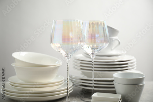 Set of clean dishes and glasses on table