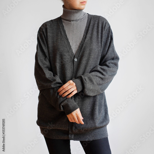 Photos Woman wearing gray turtleneck, cardigan and black jeans isolated on white backgr