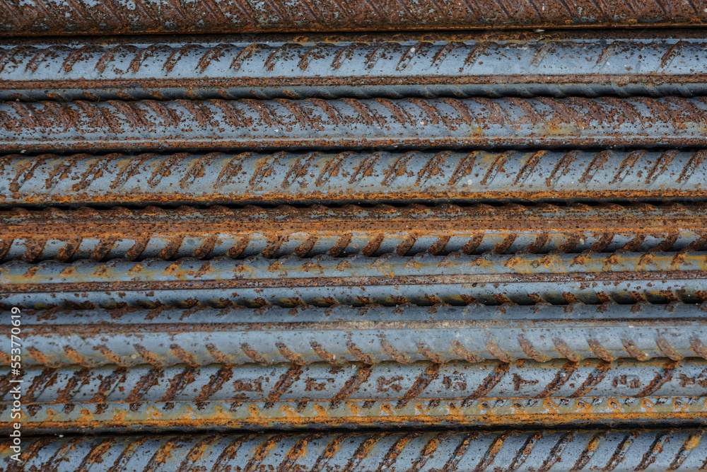 Stack of heavy metal reinforcement bars with periodic profile texture. Close up steel construction armature. industrial background. Rusty fittings. Construction, metal material. Close up. texture