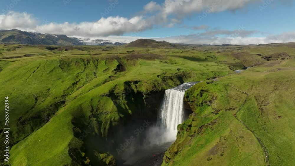waterfall in the mountains of Iceland volcanic glacier in background aerial sunny day waterfall in the mountains of Iceland volcanic glacier in background aerial sunny day