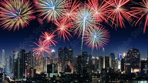 Amazing beautiful colorful fireworks display on celebration night, showing on the city night background 