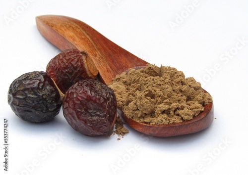 Sapindus mukorossi or Indian soapberry powder on wooden spoon  photo