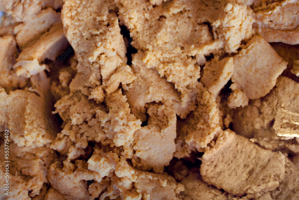 Hummus texture with chickpeas close up - healthy and tasty food recipe for vegans seen from above Hummus texture with chickpeas close up - healthy and tasty food recipe for vegans seen from above