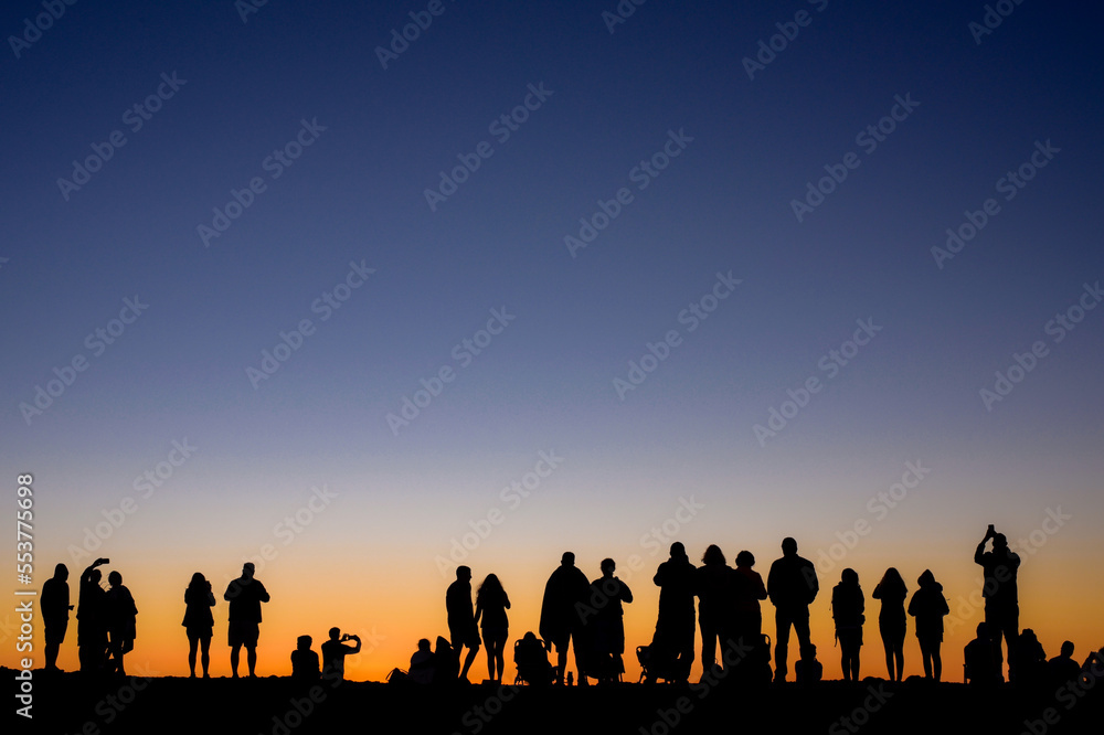 Group of people at sunset Group of people at sunset