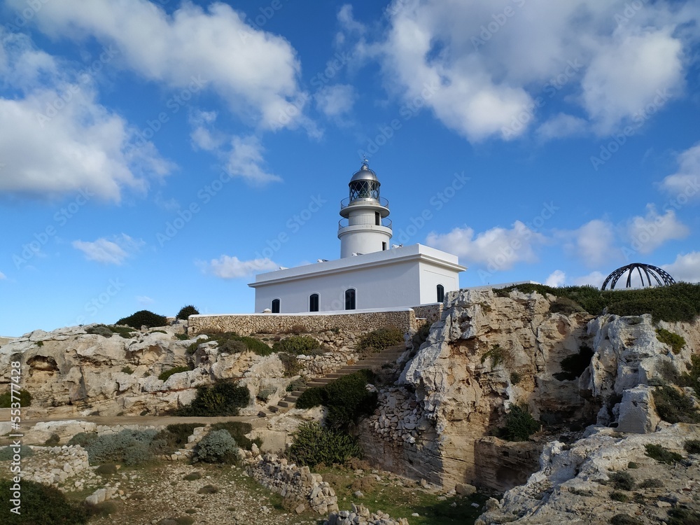 cape cavalleria lighthouse on the edge of a cliff protecting the ships of the Mediterranean sea