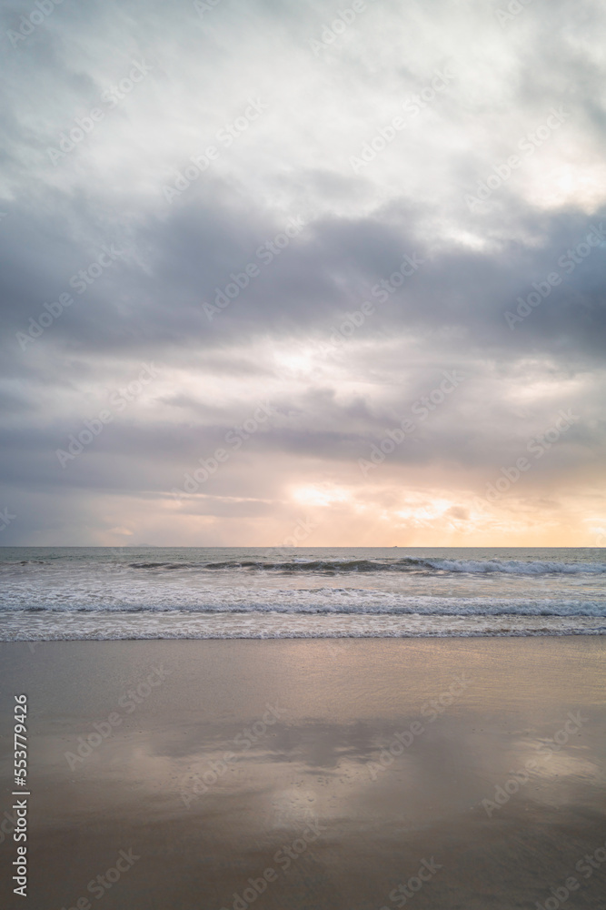 Sunset on the Coronado Beach Series with dramatic cloudscape, rolling waves, and wet reflection on the sand in San Diego, California, USA, tranquil seascape backgrounds