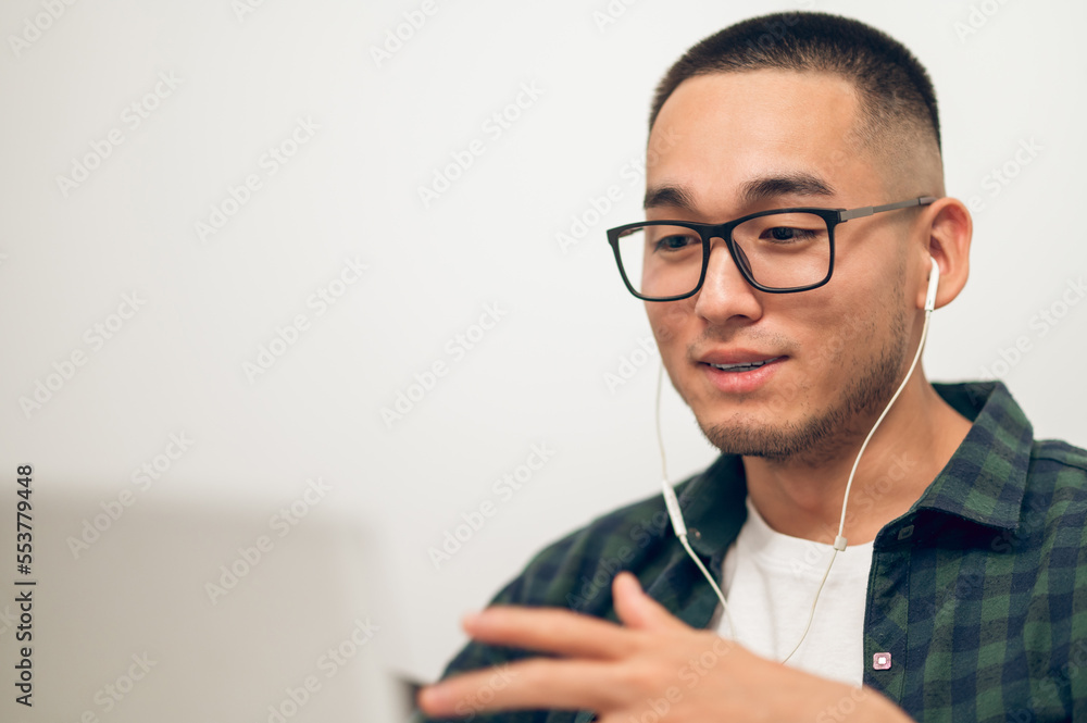 Freelancer communicating with someone via Skype using earphones Freelancer communicating with someone via Skype using earphones