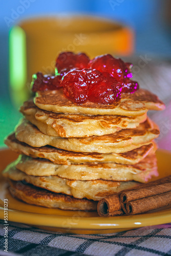 stack of pancakes with red strawberry jam