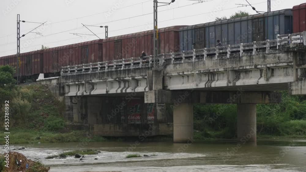 Pillars in flowing river water holding a railway bridge