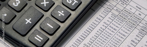 close-up the calculator lies on the accounts. Workplace panorama.