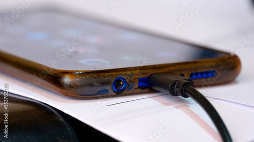 Close-up view of old dusty android smartphone charging port with usb-c cable