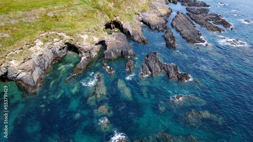 Rocky shores of the Celtic Sea along the route of the Wild Atlantic Way  top view. Seascape of the southern coast of Ireland. Beautiful rocky slopes. Drone point of view. View from above.