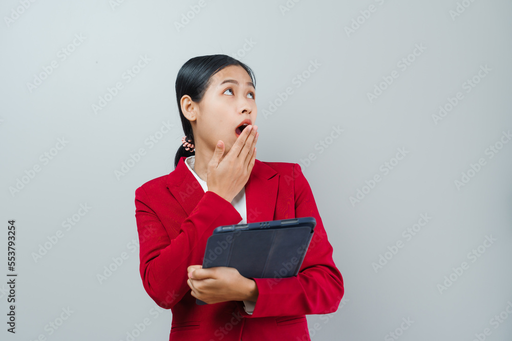 Pretty lovely manager lady successful business asian women in red suit isolated over background. Holding and using tablet computer Pretty lovely manager lady successful business asian women in red suit isolated over background. Holding and using tablet computer