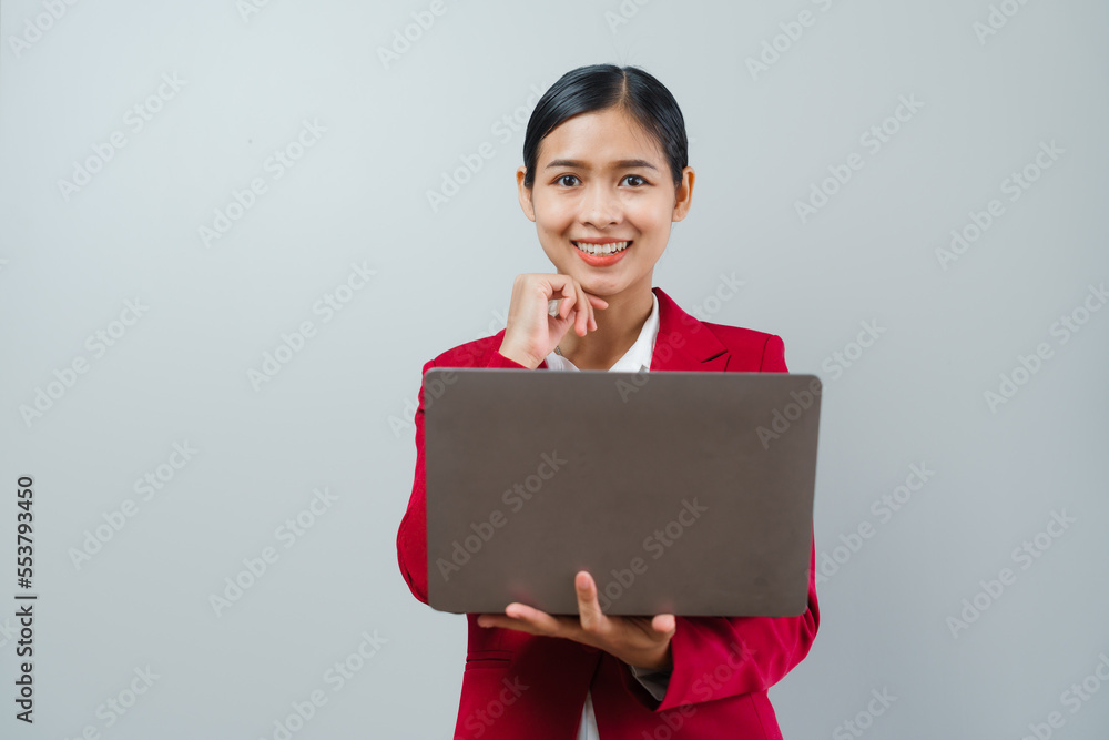 Pretty lovely manager lady successful business asian women in red suit isolated over background. Holding and using laptop computer Pretty lovely manager lady successful business asian women in red suit isolated over background. Holding and using laptop computer