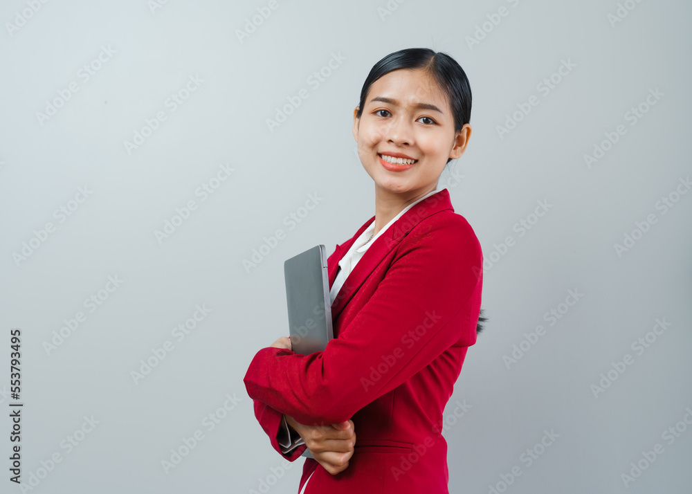 Pretty lovely manager lady successful business asian women in red suit isolated over background. Holding and using laptop computer