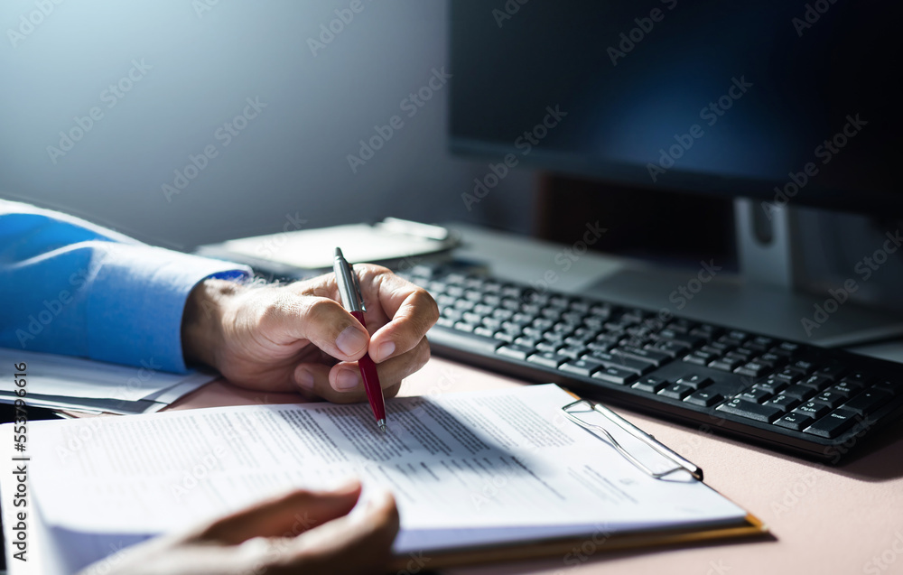 Fototapeta premium Close-up view on desk office, businessman checking a contract of investment or insurance, legal agreement before sign, Starting successful partnership with entrepreneur or companie, making good deal