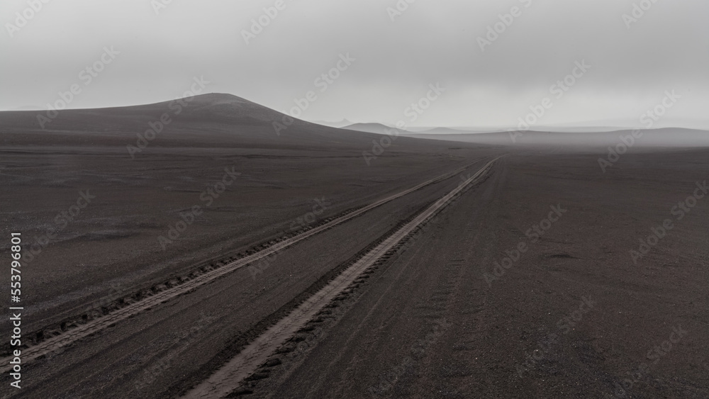 Naklejka premium Solo travel through the volcanic wilderness of Iceland on a foggy day.