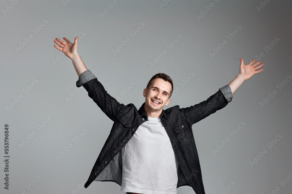 amazed man celebrating victory on gray background. amazed man celebrating victory on gray background.