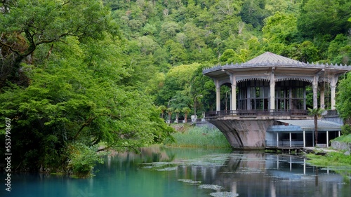 New Athos, Abkhazia, Georgia - June 2022. View of the building of the Psyrtsha railway station in New Athos from the side of the lake.