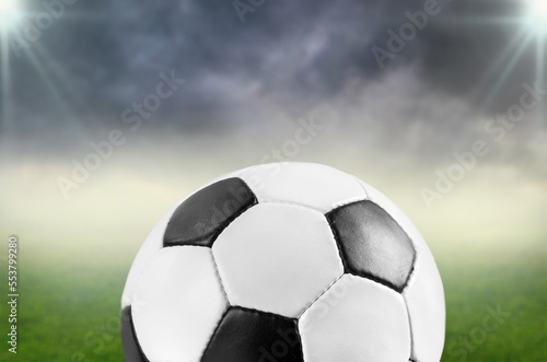 Football or soccer ball at big stadium