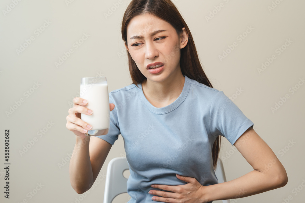 lactose intolerance concept. Woman pushing glass of milk deny to drink. lactose intolerance concept. Woman pushing glass of milk deny to drink.
