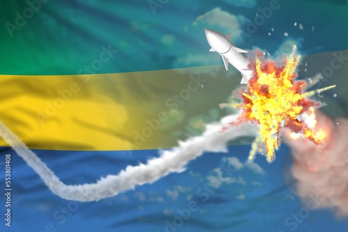 Gabon intercepted nuclear warhead, modern antirocket destroys enemy missile concept, military industrial 3D illustration with flag photo