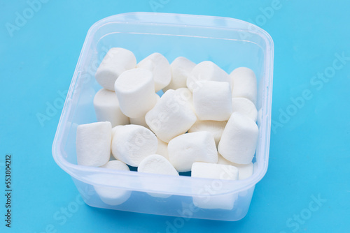 Delicious white marshmallows on blue background.