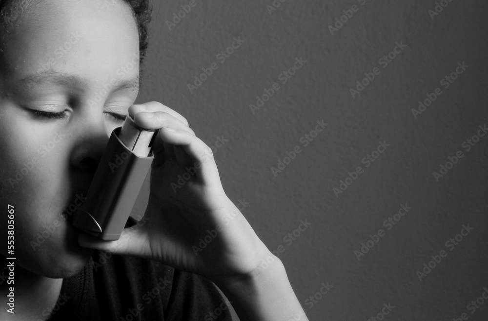 child with flu with inhaler respiratory puff on grey background with people stock photo child with flu with inhaler respiratory puff on grey background with people stock photo