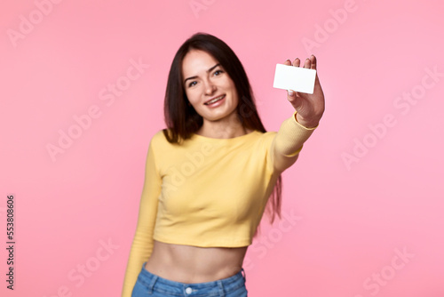 woman in yellow clothes holding plastic credit card © producer