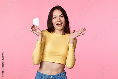 woman in yellow clothes holding plastic credit card