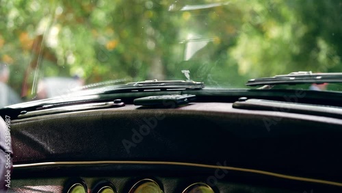 Vintage classic car windshield and dashboard medium shot