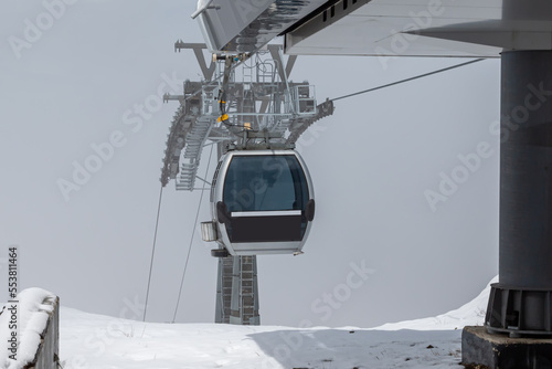Gondola lifts on top of the mountain in winter photo