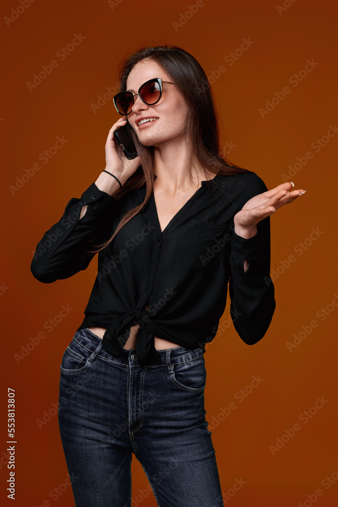 woman in black shirt and jeans using mobile cell phone woman in black shirt and jeans using mobile cell phone