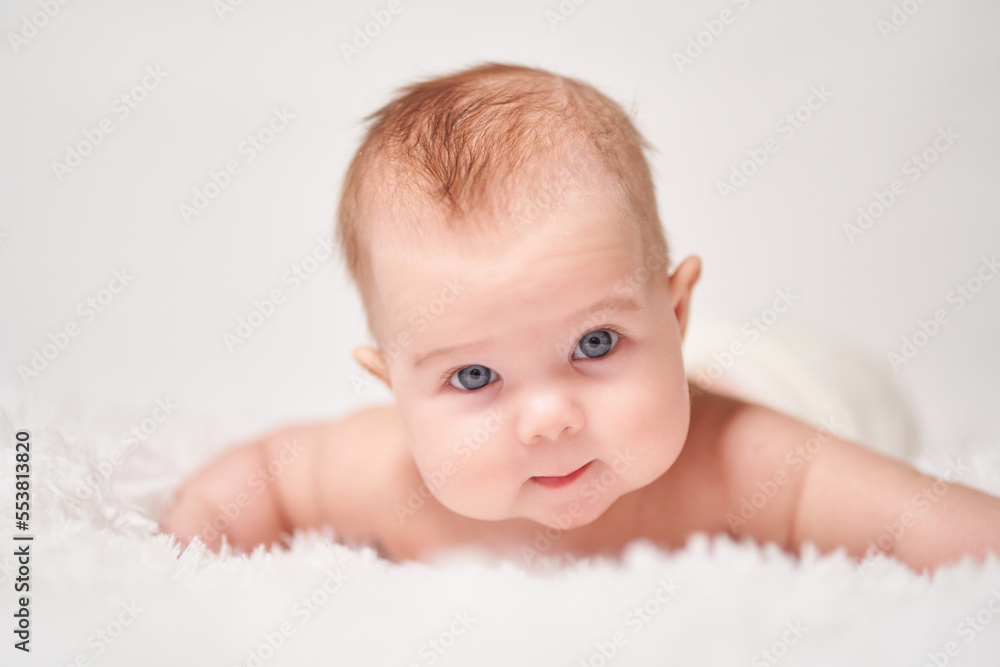 portrait of a child looking into the camera on a soft blanket portrait of a child looking into the camera on a soft blanket