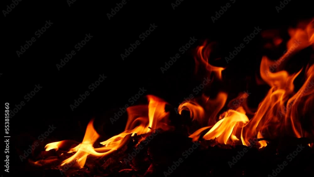 Fire burning red flame effect behind substance low on ground in the dark Fire burning red flame effect behind substance low on ground in the dark