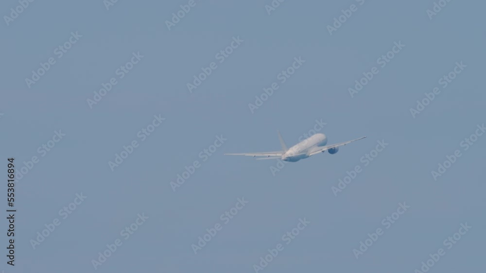 Widebody plane climbing after takeoff, fly away, long shot. Airliner in the blue sky. Airplane flying, side view Widebody plane climbing after takeoff, fly away, long shot. Airliner in the blue sky. Airplane flying, side view