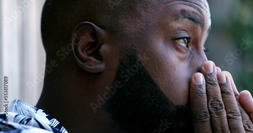 Upset man, worried African person feeling stress and anxiety close-up face