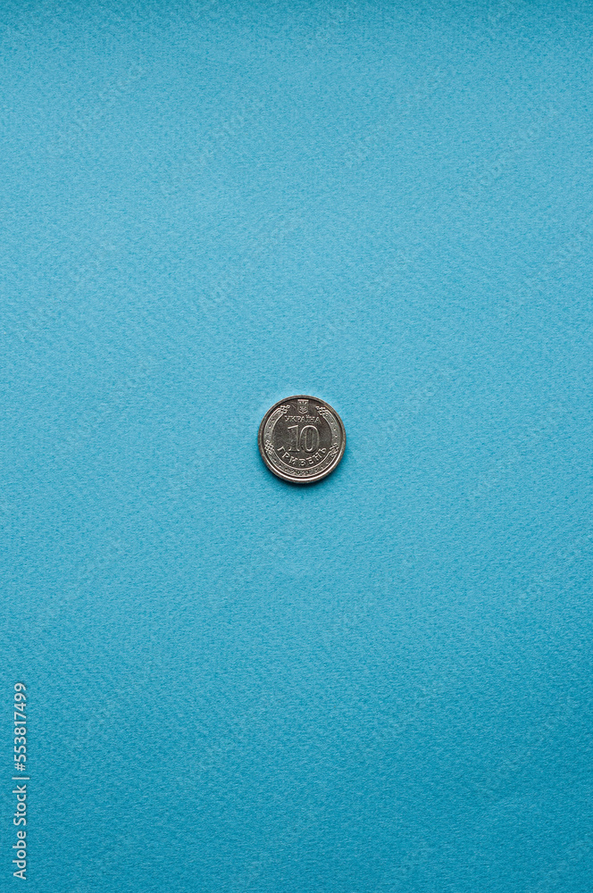 one coin on a blue background money currency metal hryvnia finance stash investments accumulation one coin on a blue background money currency metal hryvnia finance stash investments accumulation