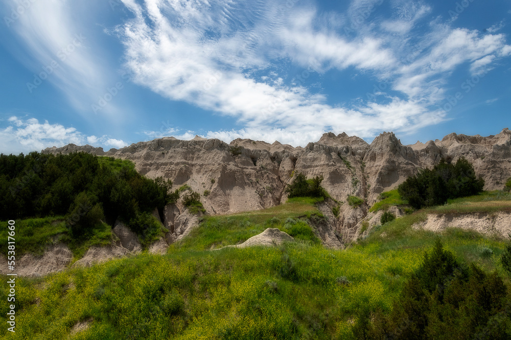 The rugged mountains of the Badlands. These geologic deposits contain one of the world’s richest fossil beds. Ancient mammals such as the rhino, horse, and saber-toothed cat once roamed here