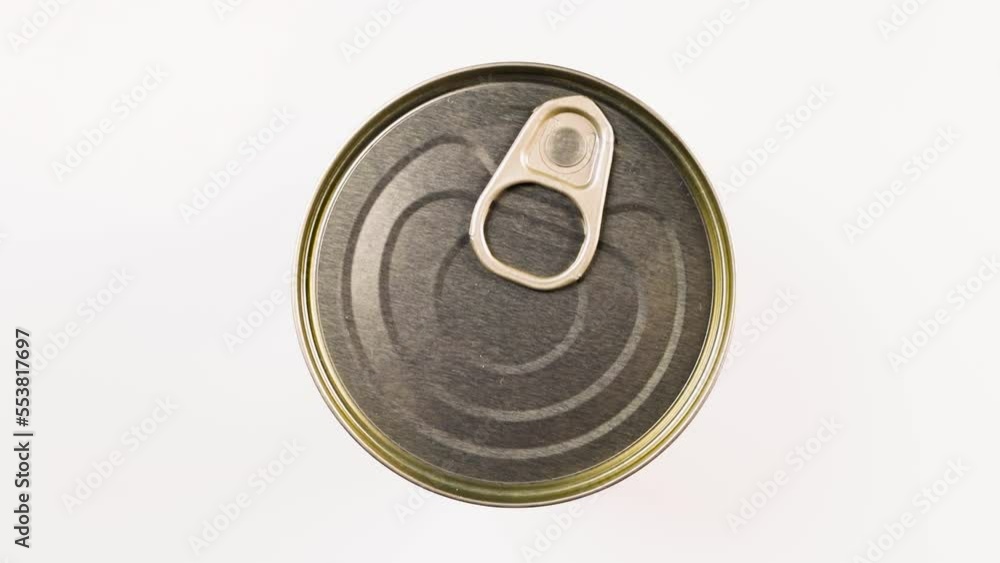 Metallic tin can with canned food spinning on a white background. Tourist food, military or humanitarian aid Metallic tin can with canned food spinning on a white background. Tourist food, military or humanitarian aid