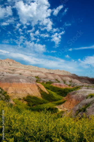 The rugged mountains of the Badlands. These geologic deposits contain one of the world   s richest fossil beds. Ancient mammals such as the rhino  horse  and saber-toothed cat once roamed here
