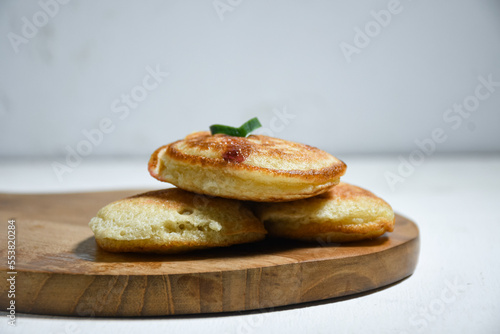 Kue Khamir or samir or Khamir cake on wooden plate. Khamir cake is a traditional snack from Pemalang, Indonesia. This cake is made from flour, butter and egg dough. Selective Focus photo