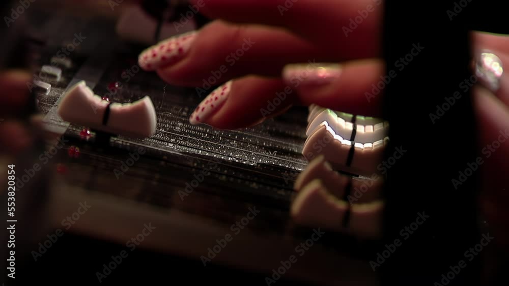 Female Hand on Mixing Console in Studio. Close Up. 4K Resolution. Female Hand on Mixing Console in Studio. Close Up. 4K Resolution.
