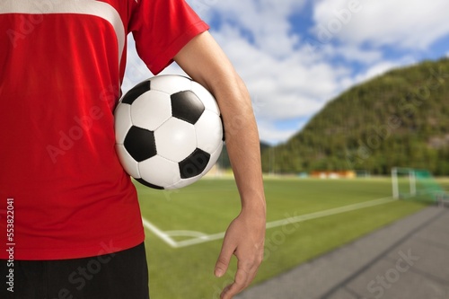 Soccer fan holding a ball on background © BillionPhotos.com