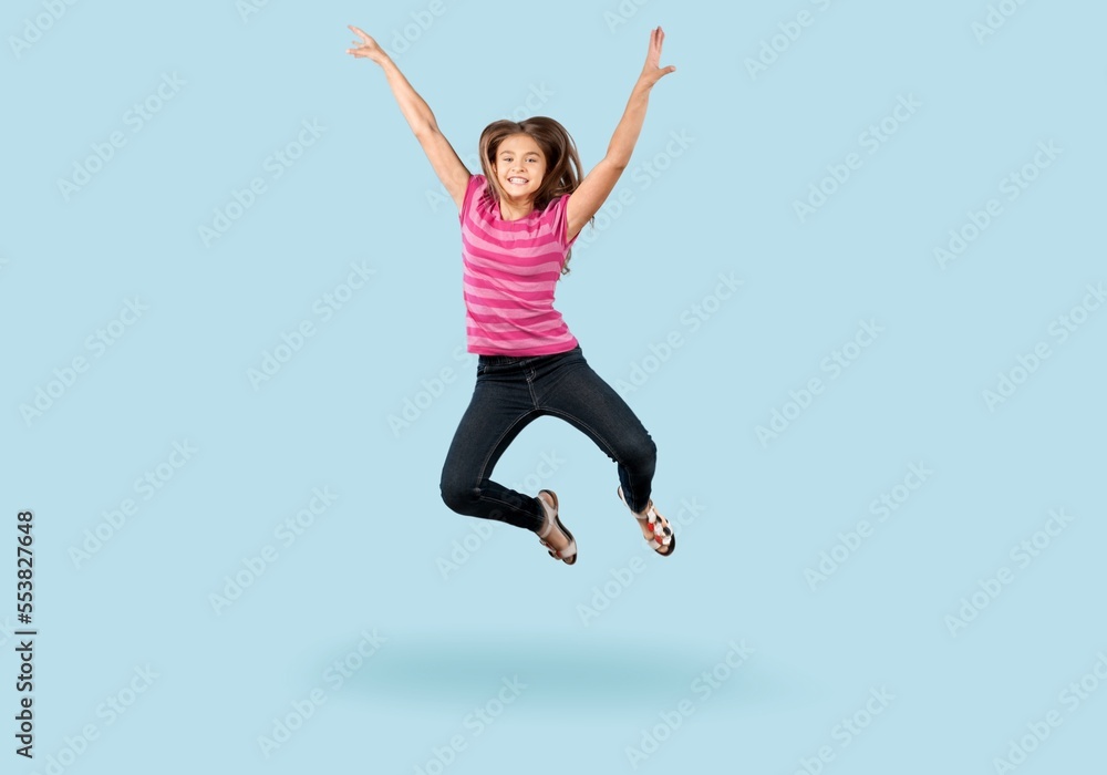 Energetic cute child jumping and posing