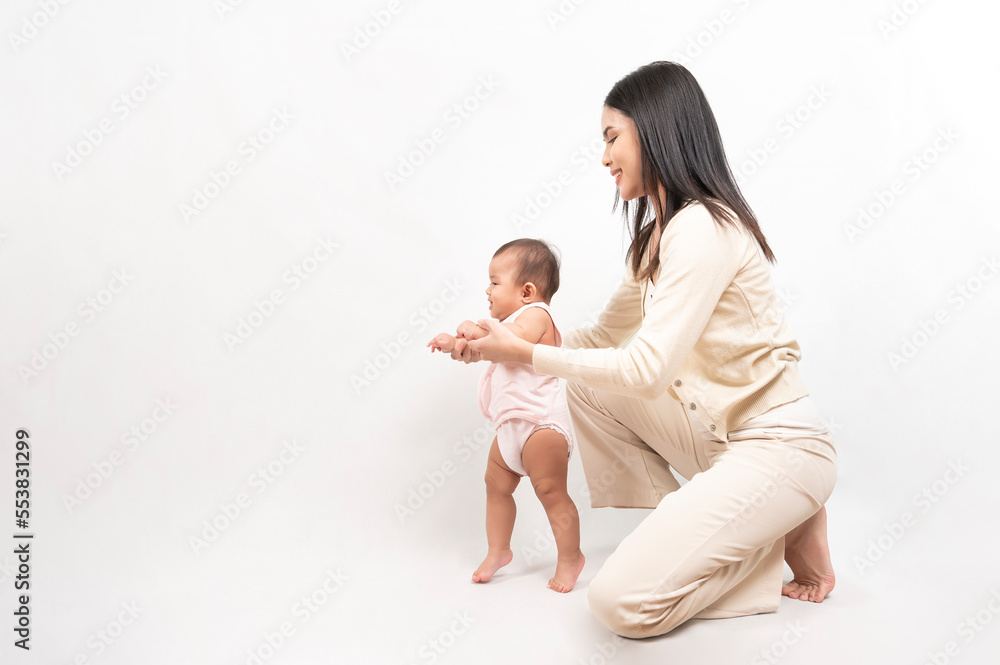 Beautiful mother and adorable baby girl are happy on white background, family, child, childhood and parenthood concept Beautiful mother and adorable baby girl are happy on white background, family, child, childhood and parenthood concept