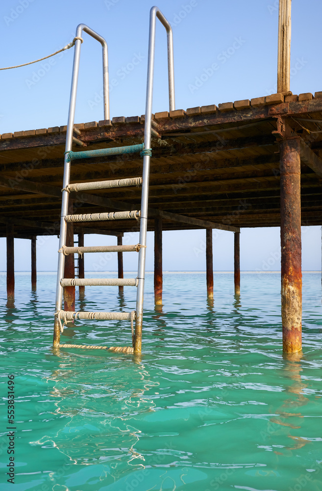 Picture of a pier swim ladder, tropical summer vacation concept.