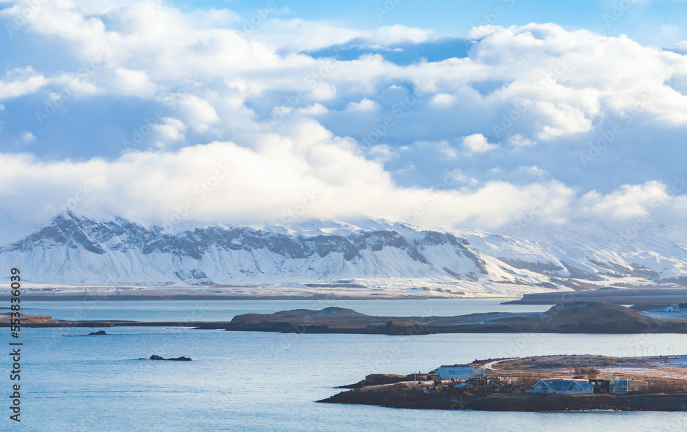 Landscape photo of Reykjavik bay with snowy coastal mountains
