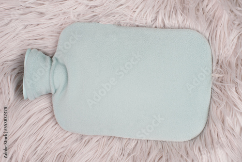 Foto Hot water bottle on a fur, freezing winter, keep warm, high energy costs