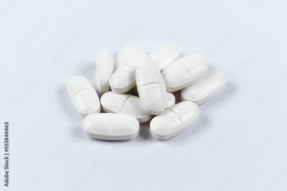 many white oval medical tablets for humans and animals, medicinal antibiotics pills medicine closeup many white oval medical tablets for humans and animals, medicinal antibiotics pills medicine closeup